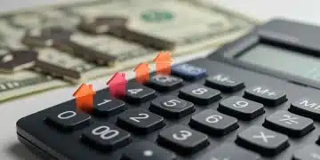 Calculator, house key, and dollar bills symbolizing rising interest rates and mortgage refinancing decisions.